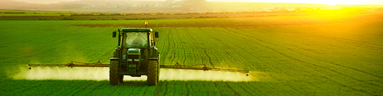 Tractor spraying in the field